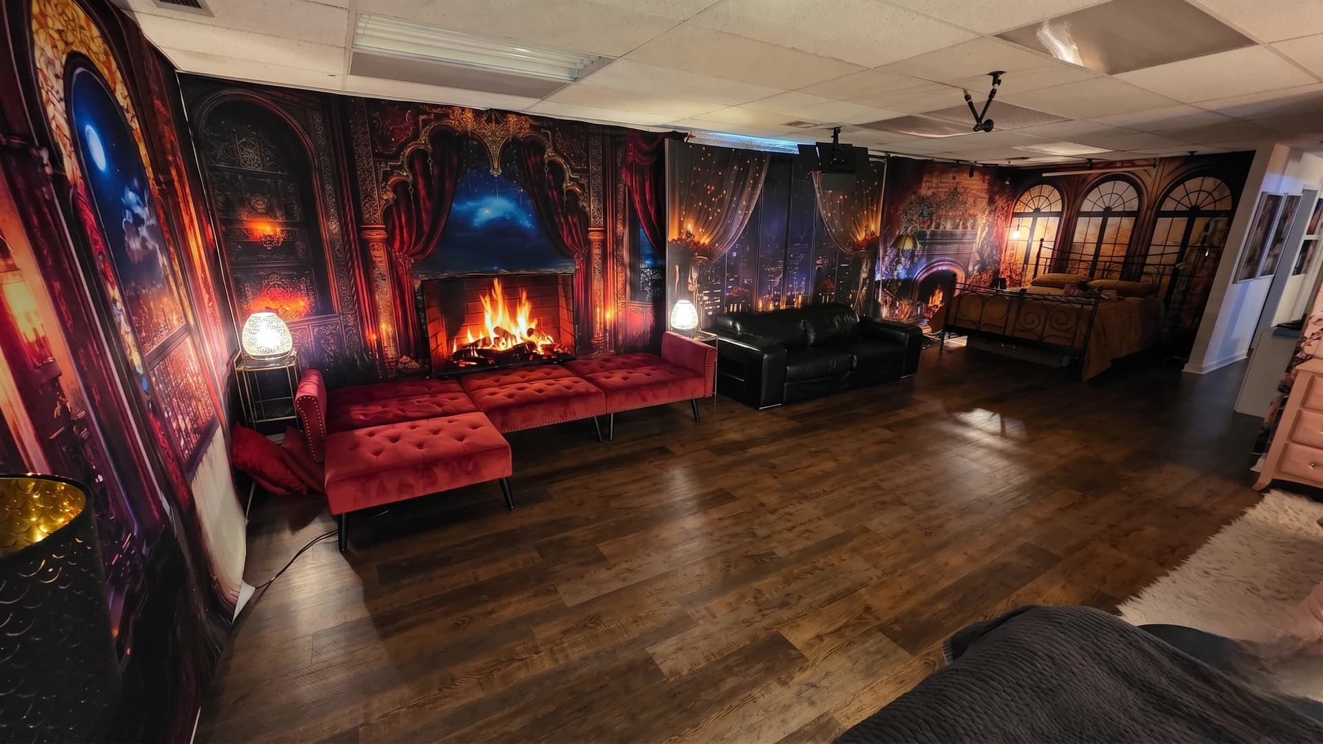 Casey Quist's studio gothic and dark sets — red velvet couch, fireplace backdrop, moody dark leather seating area