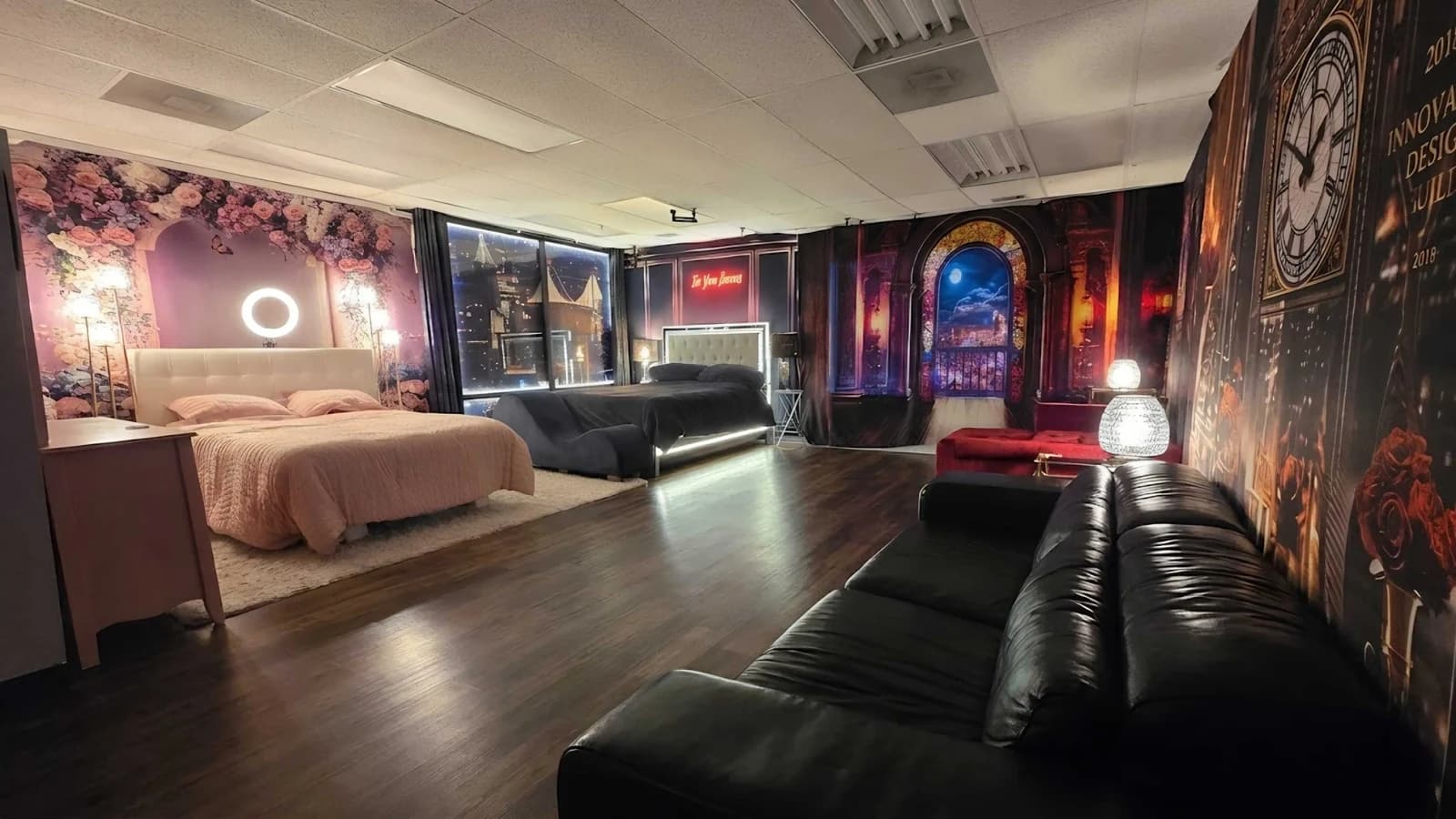 The finished interior of Casey Quist's custom Concord, California boudoir studio — four dramatic shooting sets: pink floral, navy cityscape, gothic arch, and leather lounge, all professionally lit
