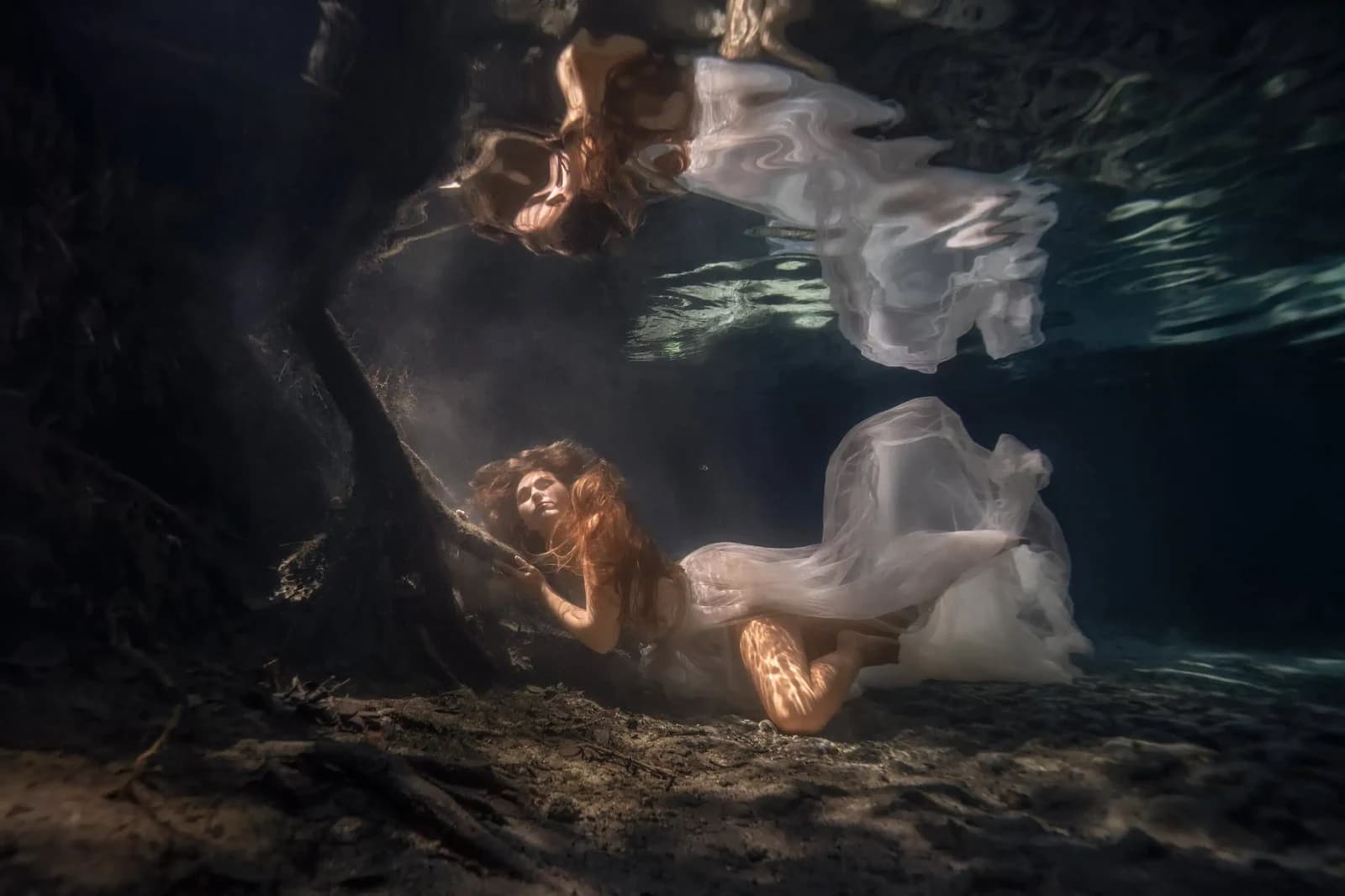 Underwater photography session: woman floating in a cenote